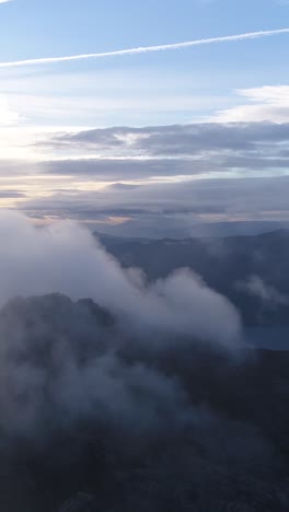 flying over clouds mountain landscape blue sky vertical video