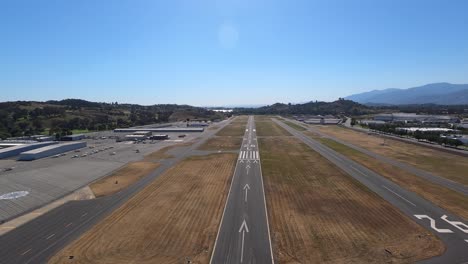 a forward aerial view approaching the runway at brackett field near la verne, california