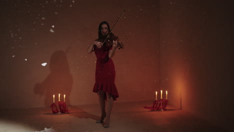 woman playing violin in winter wonderland