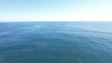 Flyby-over-the-Ocean-Approaching-a-Kayak-on-a-Sunny-Day