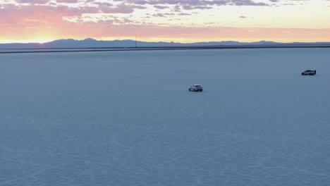 vehicle and people in bonneville salt flats at sunset, utah