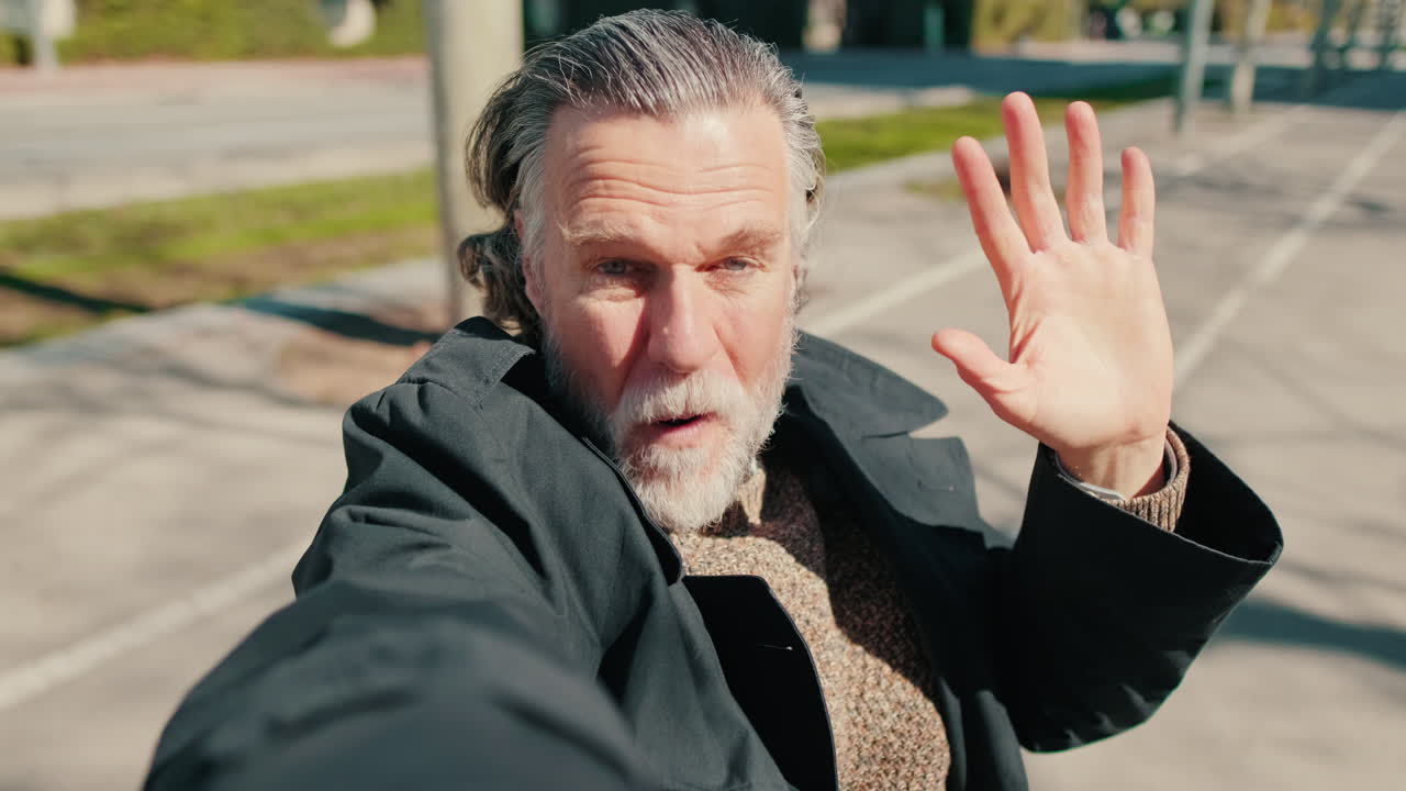 Happy Senior Man Waves in Selfie Video
