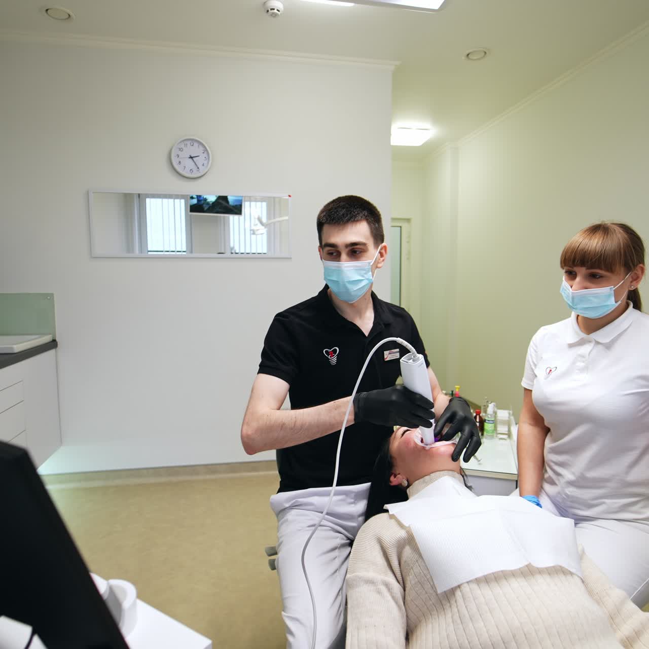 Handsome medical doctor working. Hospital dental specialist perfoming with microscope