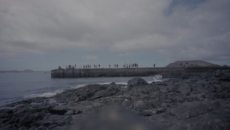 tourists waiting for boat to leave a volcanic island