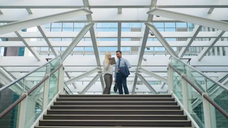 business people meeting on stairs in modern city