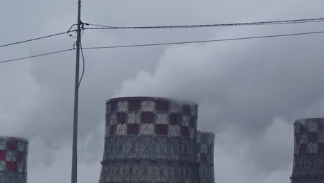 steam from the pipes and boilers of the city thermal power plant. global warming. pollution and danger for earth