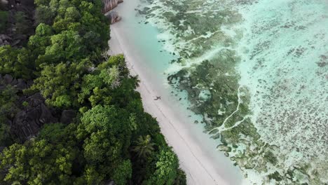 Aerial-view-of-Anse-Source-d’Argent,-La-Digue,-Seychelles-shot-in-the-early-morning-hours-with-no-people-on-the-beach