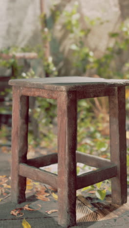 close-up of an old wooden stool in a rustic setting