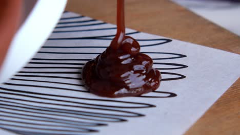 close up of brown sauce dripping onto a surface