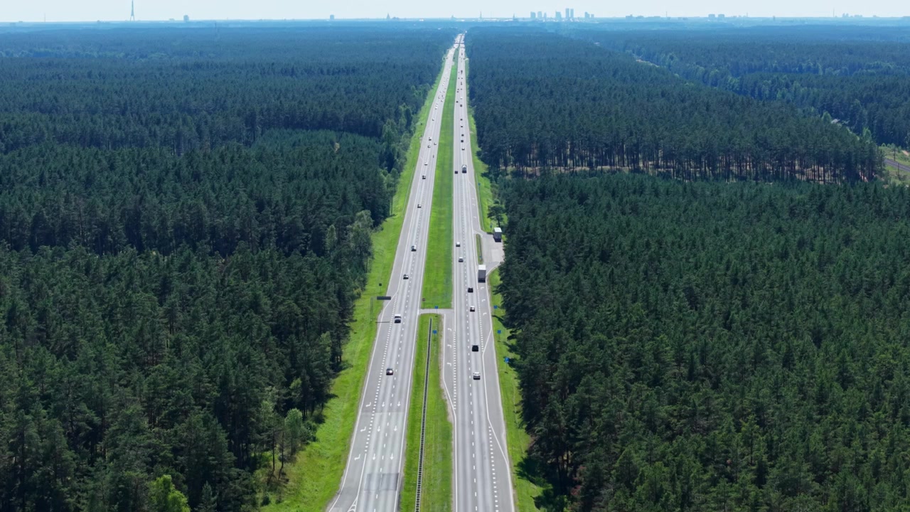 Drone flies forward, tilting from top-down to forward, Garkalne Parish highway