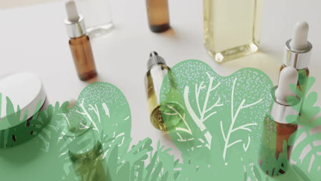 animation of green plants leaves and trees over organic beauty products in jars and bottles