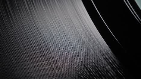 close up, macro shot of old vinyl disc spinning on a record player