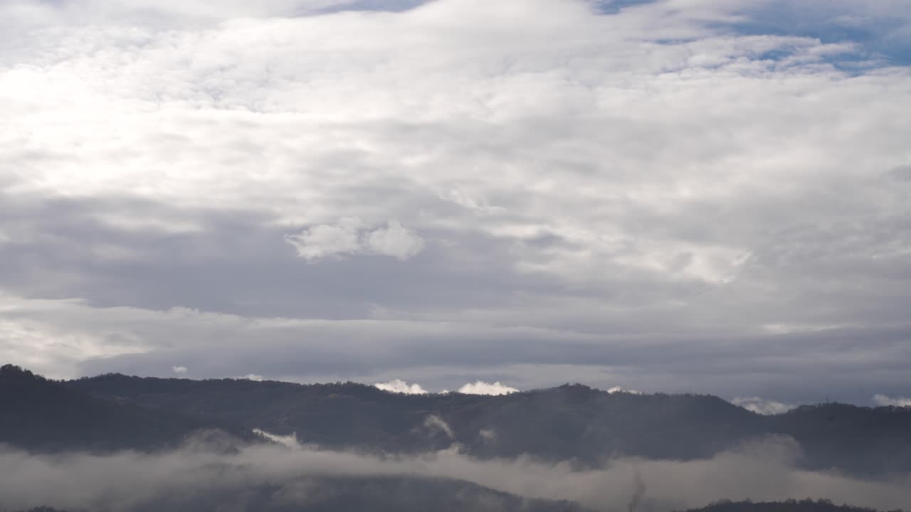 Mist and dark clouds move together over mountains perfect for weather and nature footage