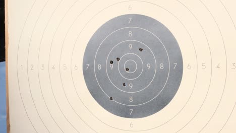 the target for shooting is pierced by bullets in the shooting range. target for practical pistol shooting with bullet holes. range shooting practice