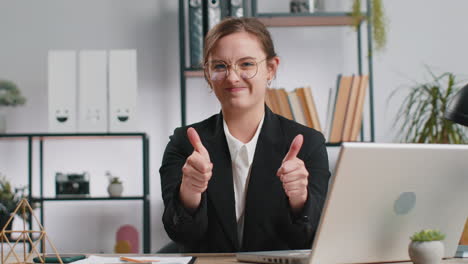 Happy-business-woman-looking-approvingly-at-camera-showing-thumbs-up,-like-positive-sign,-good-news