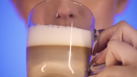 Woman-drinking-a-glass-of-beer-and-smiling