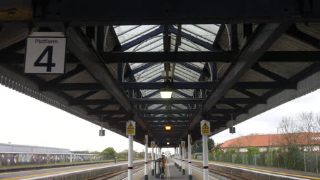 deserted railway platform viewed from behind safety gates