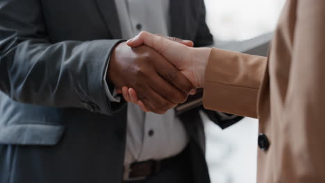 close up business people shaking hands  corporate partnership deal welcoming opportunity for cooperation in office