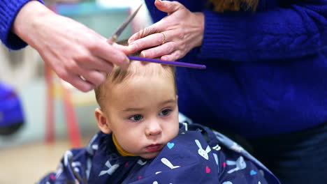 baby getting a haircut at the salon