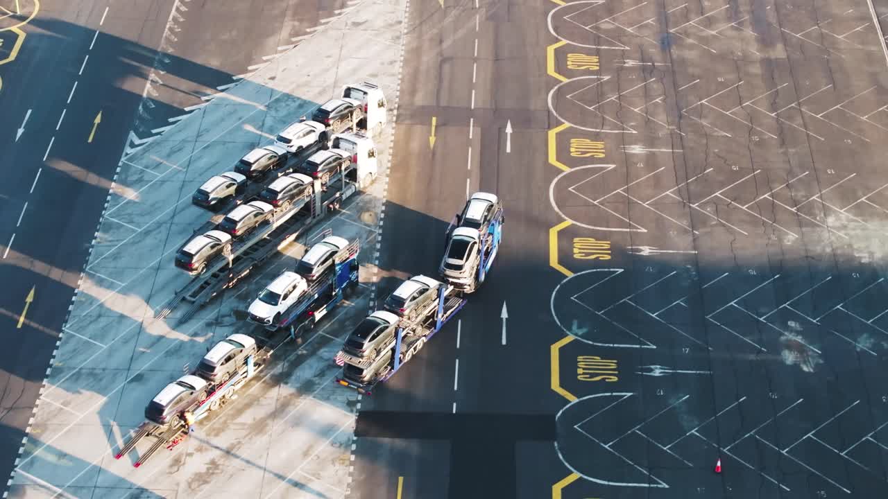 Aerial - car carrier trailer transport new vehicles from company parking lot