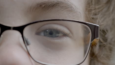 Closeup-on-a-young-boy's-pretty-blue-eye-looking-into-camera