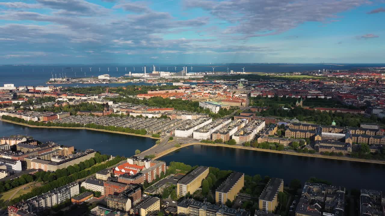 Panoramic View Of Coastal City With Offshore Wind Turbines In The Distance. - aerial panning. Copenhagen