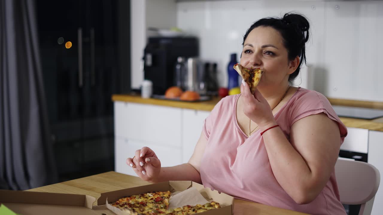 Overweighted woman eats with great pleasure, woman eats pizza, rolls eyes, slow motion