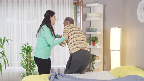 nursing woman helping old sick man and showing love.