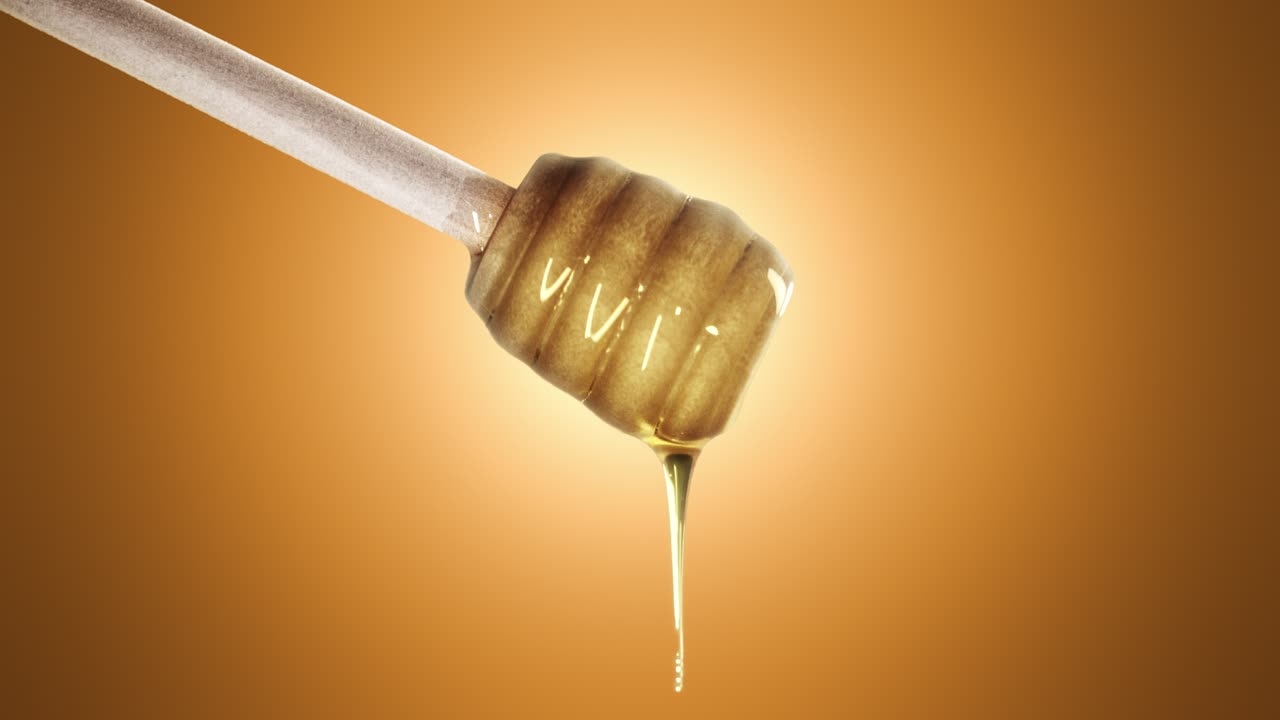 Honey dripping from honey dipper on orange background