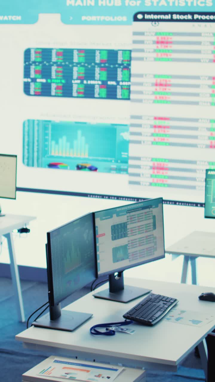 Empty Modern Office with Computers and Financial Data Display