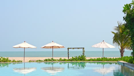 view from tropical infinity pool on white sand beach and endless seascape