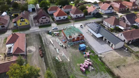 drone view of small town with residential house under roof construction