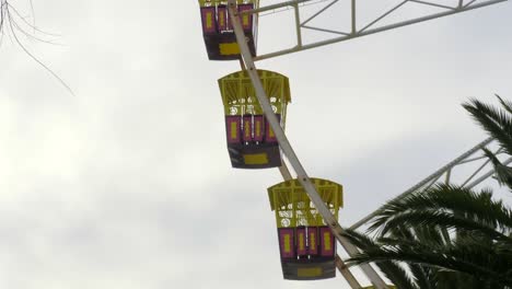 ferris wheel empty spinning against a winter skyscape, slow motion