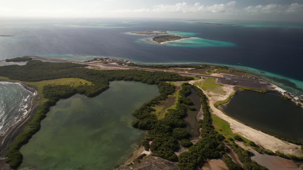 Los roques with turquoise waters, lush islands, and runway at gran roque , aerial view