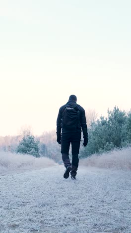 man hiking in winter landscape