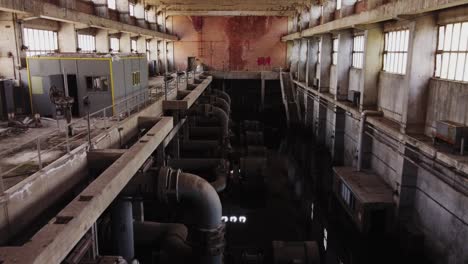 Aerial-flight-inside-abandoned-old-power-factory-in-Ptolemaida-City-during-sunny-day