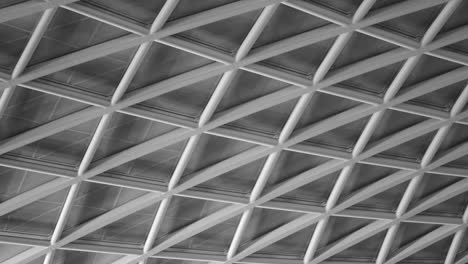 Black-And-White-Closeup-Of-Double-Barrel-Vaulted-Glass-Ceiling-Of-King's-Cross-Railway-Station-In-London,-UK