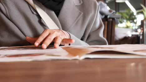 woman reading a menu at a restaurant