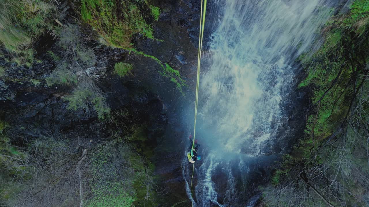 Aerial View Of Person Rappelling Down A Cliffside Waterfall - Fervenza da Pedreira, Lugo, Spain. topdown shot