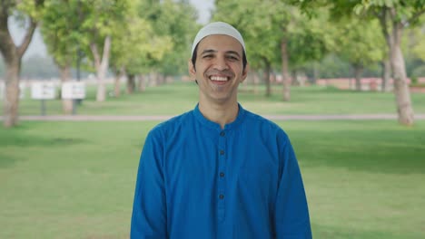 happy muslim man laughing on someone in park