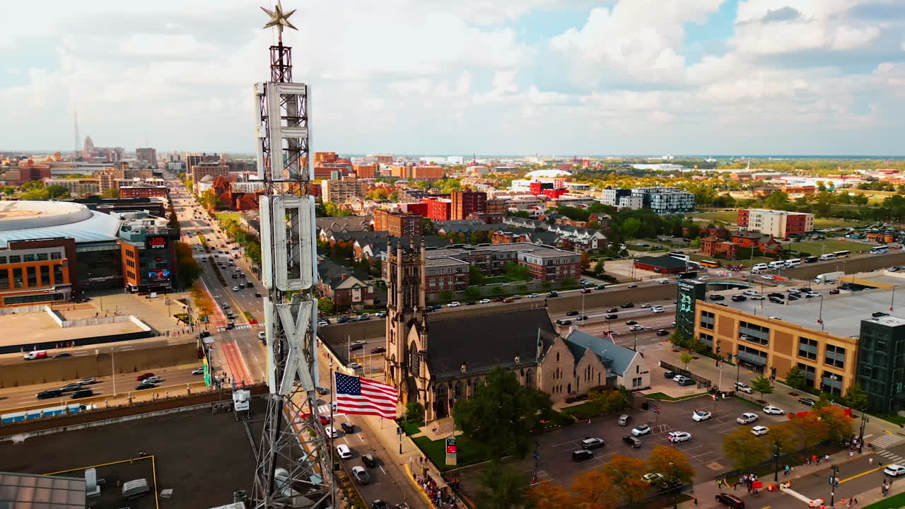 Detroit, USA, 28 July 2025: Footage around TV-tower in Detroit, Michigan. Drone flight around prominent landmark of the city located on the station's headquarters. View on the cityscape with hectic traffic in roads