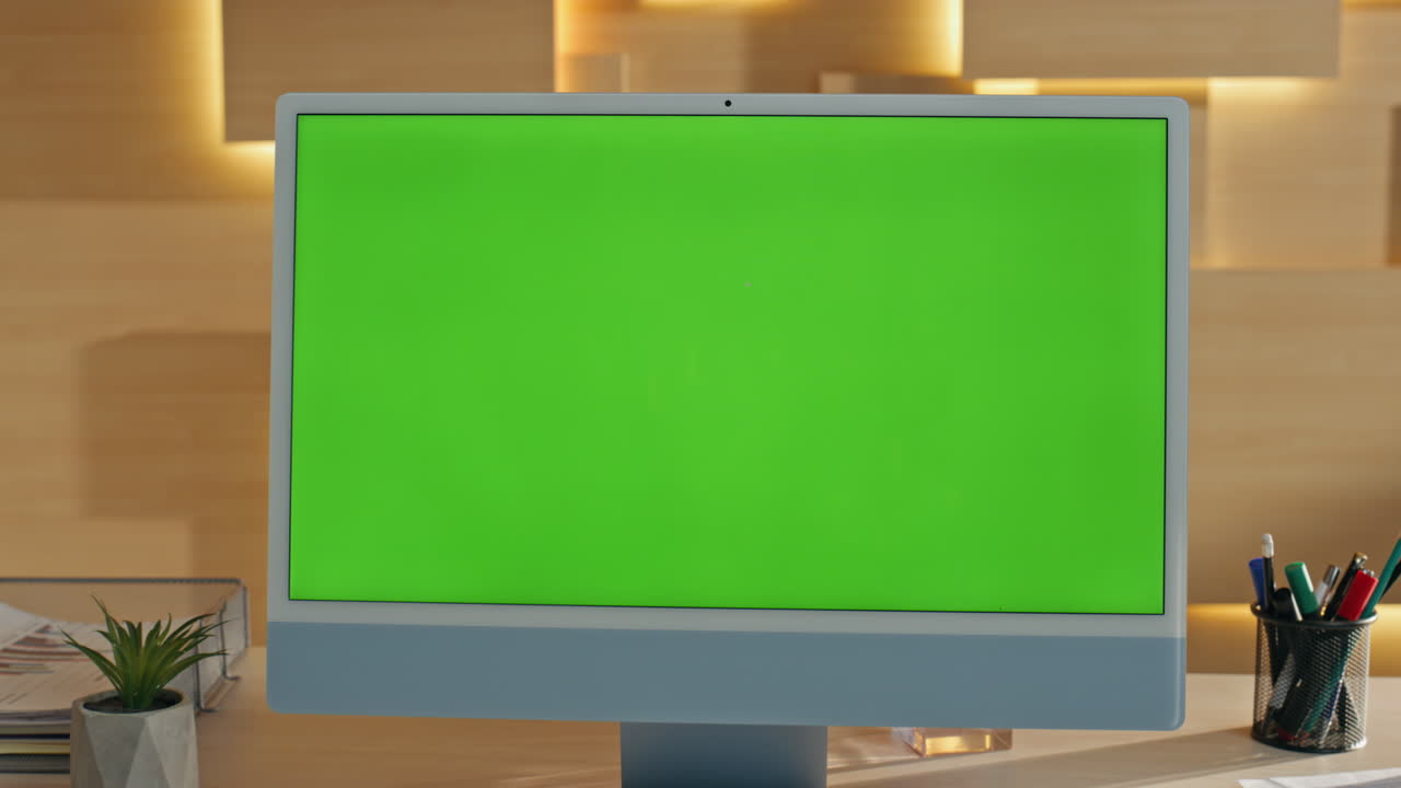 Green Screen Monitor in Modern Office Setting