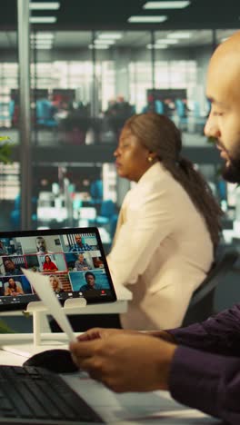vertical video worker in office talking with colleagues during internet videocall