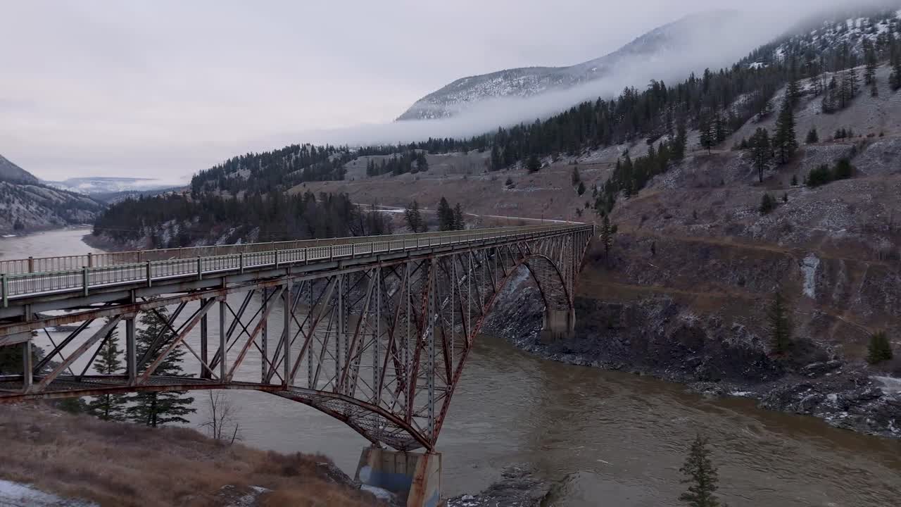 4K CGI drone aerial of a bridge spanning the Fraser River in British Columbia, capturing the stunning natural landscape and infrastructure of the region.