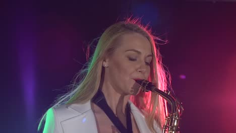 woman playing saxophone on stage
