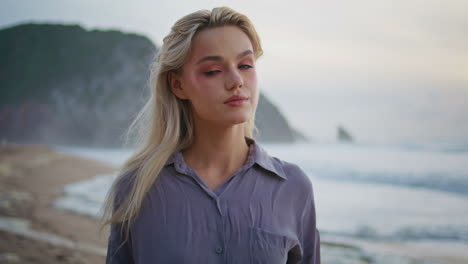 thoughtful woman enjoying sunset ocean closeup. smiling calm girl looking camera