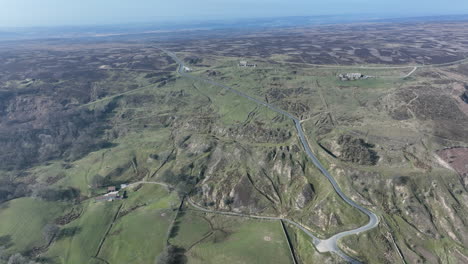 Rosedale-Abbey-Iron-Calcining-Kilns,-Aerial-Footage,-North-York-moors-National-Park,-long-distance-push-forward-above-chimney-bank-towards-kilns