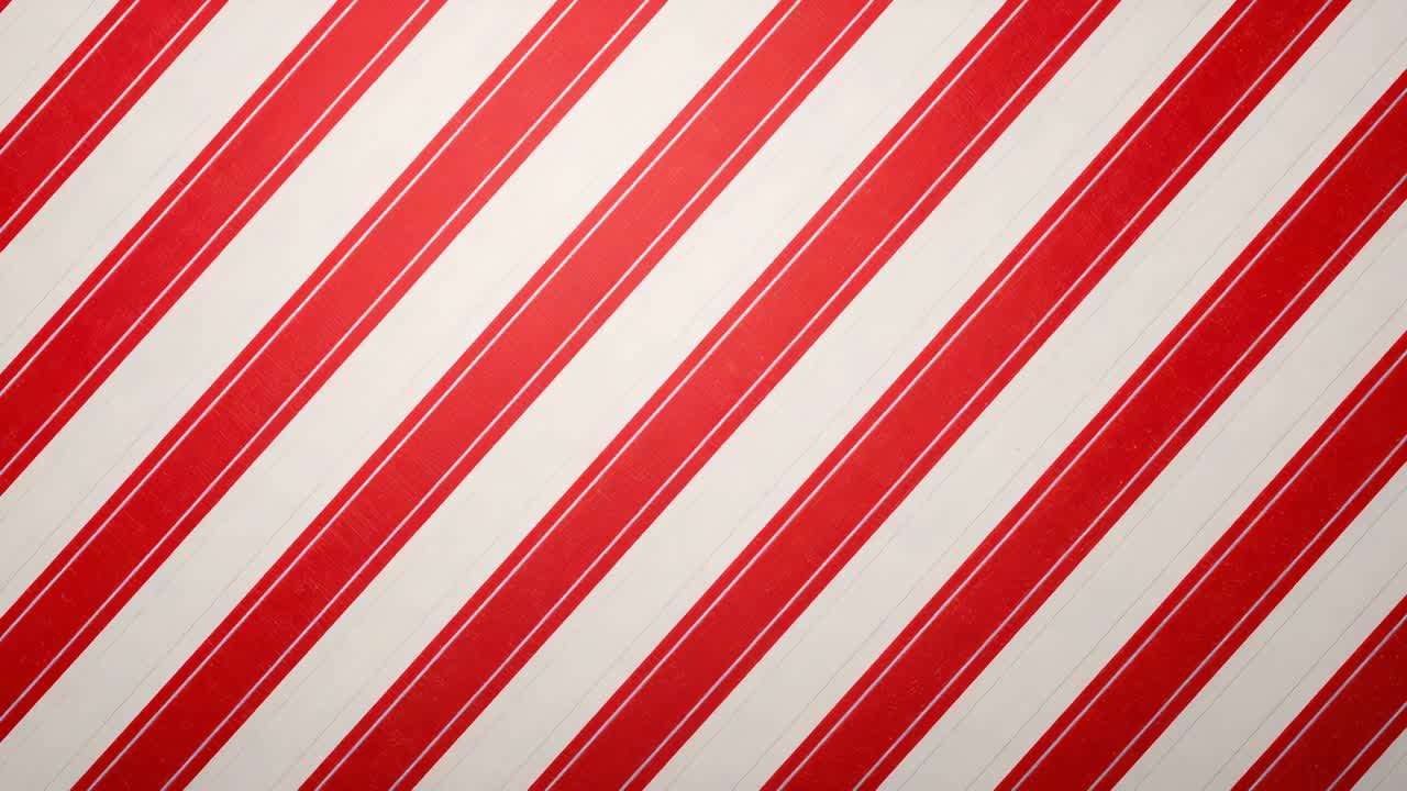 Playing diagonal red-and-white striped surface filling frame on screen, showing printed pattern