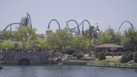 Epic-shot-of-two-different-roller-coasters-running-simultaneously-on-a-bright-sunny-day