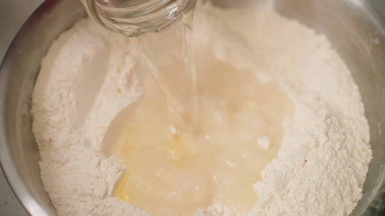 Mixing oil, water and flour to create dough
